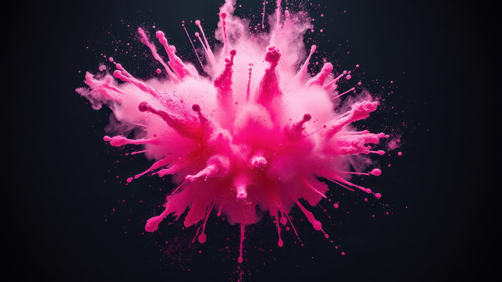 Bright pink powder bursts in a colorful explosion against a dark background during an art project in a creative studio